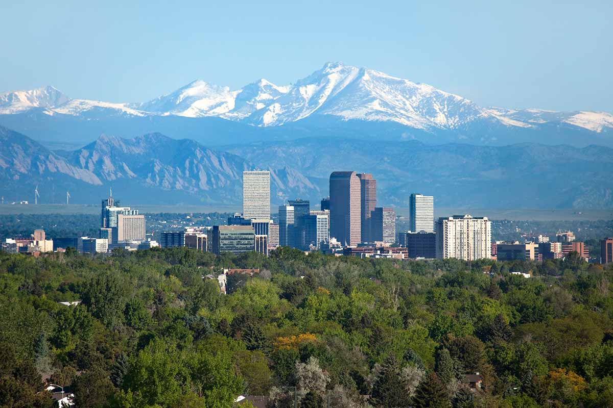 The city of Louisville, Colorado with mountains in the background